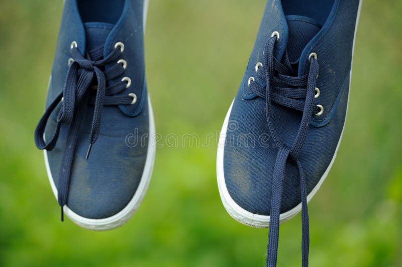 Dirty Blue Sneakers on Clothes Line