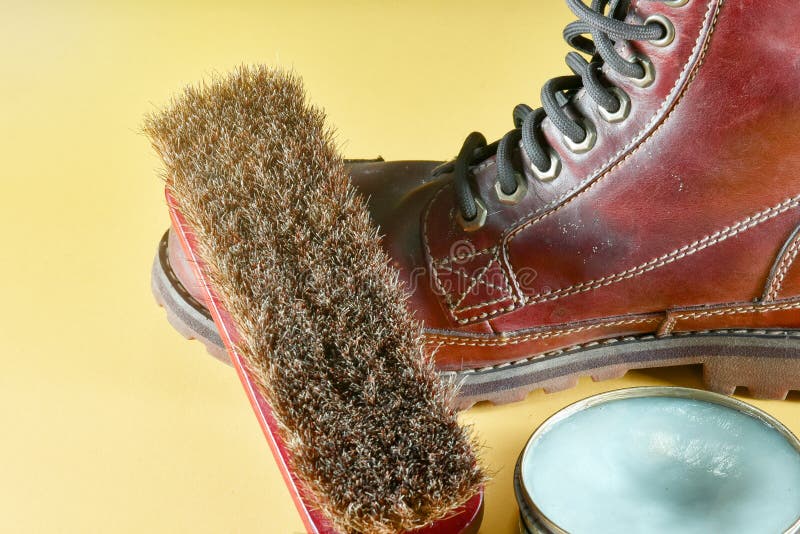 A Dirty Brown Leather Boot with Polish Kit Brown Leather Boot an Stock