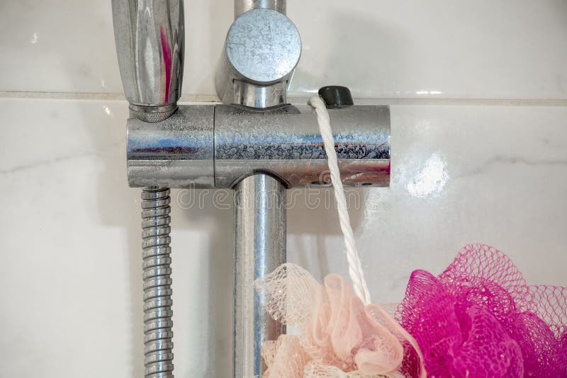 Dirty chrome shower rod with limescale that should be cleaned stock photo