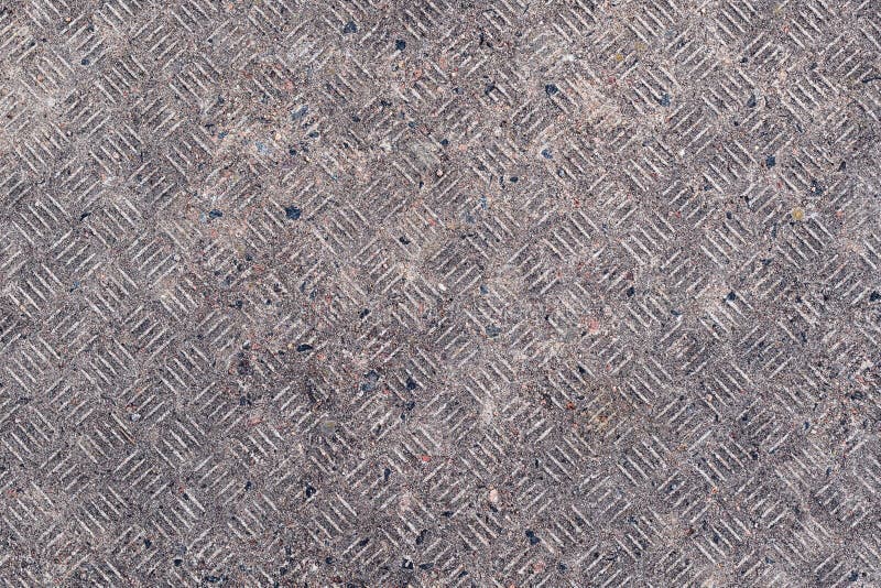 Dirty concrete surface with tread plate pattern as background stock photography