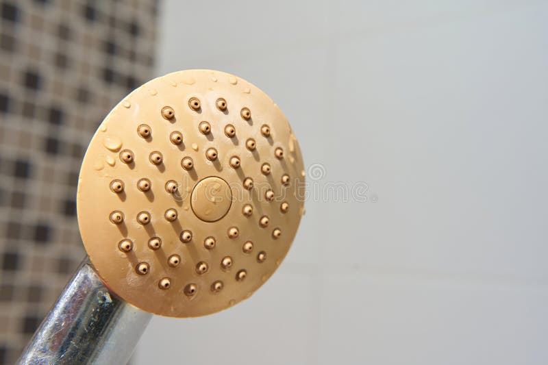 Dirty corroded limescale calcified old shower head hanging from a stand inside cabin stock photos