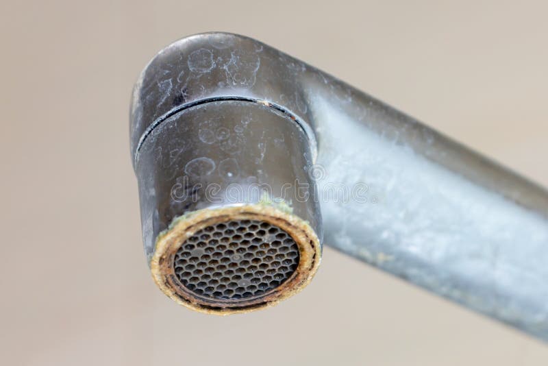 Dirty faucet aerator with limescale, calcified shower water tap with lime scale in bathroom, close up stock images