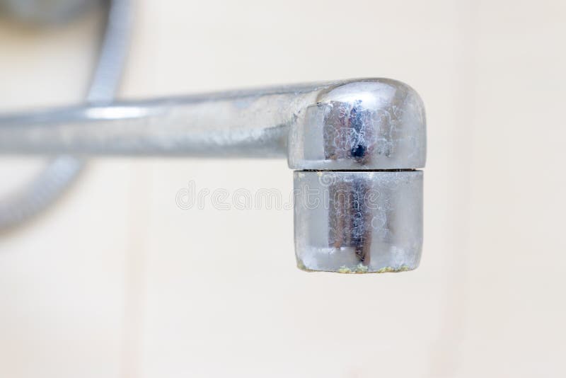 Dirty faucet aerator with limescale, calcified shower water tap with lime scale in bathroom, close up stock image