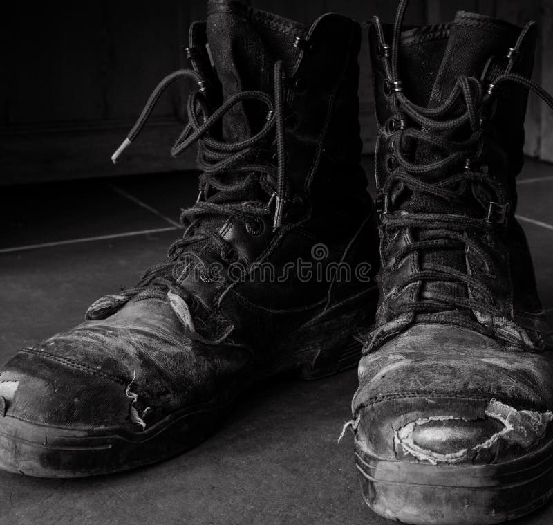 Dirty old work boots black and white