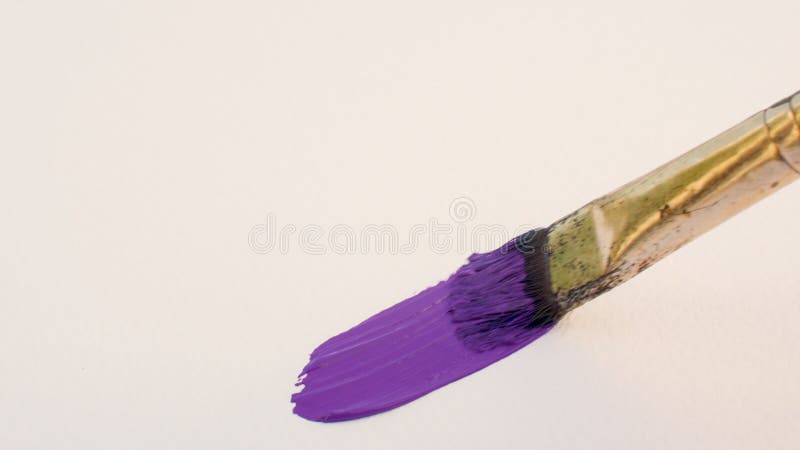 Dirty paintbrush drawing purple line with acrylic paint on textured paper, close up smear on canvas, abstract background