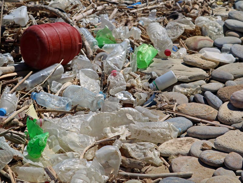 Dirty Plastic Bottles and Waste on the Stone Beach. Environmental