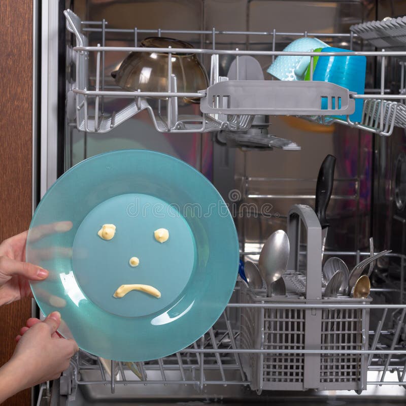 A Dirty Plate with a Sad Expression for Washing in the Dishwasher Stock