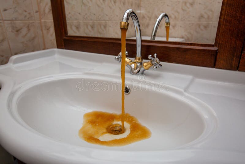 Dirty water flows from the faucet stock image Dirty water flows from the faucet stock image