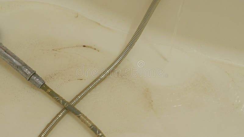 Dirty rusty water flows from the tap into the bathroom. stock video footage