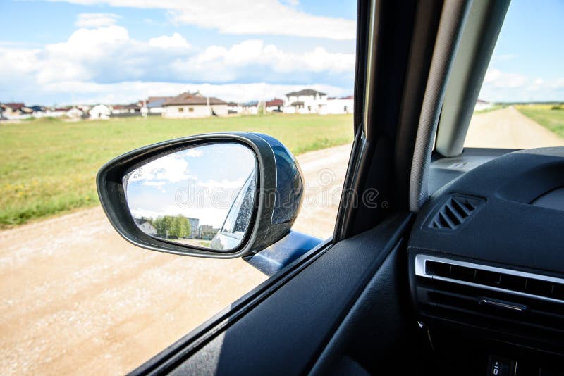 Dirty side rear-view mirror on a modern car. stock photo