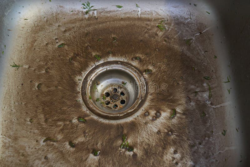 Dirty Sink in the Kitchen, a Sink with a Swamp after Washing Vegetables