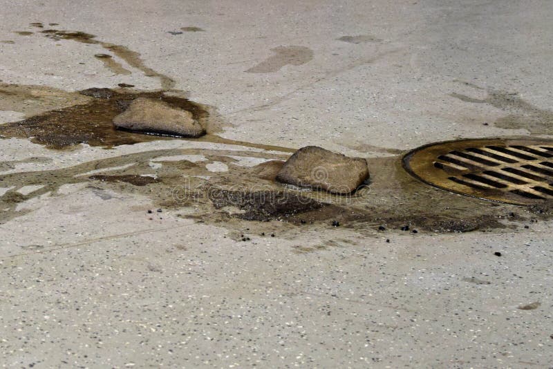 Dirty snow from car melting on garage floor