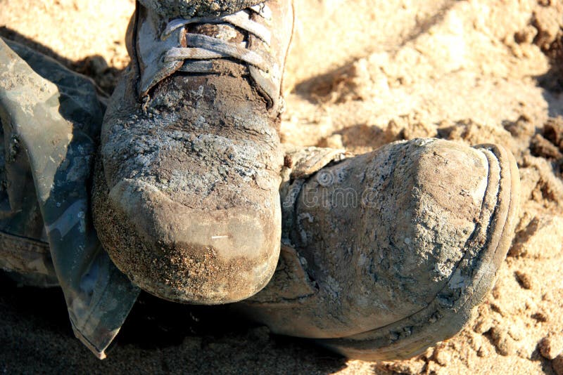 Close-up of a pair of very dirty construction boots. Close-up of a pair of very dirty construction boots