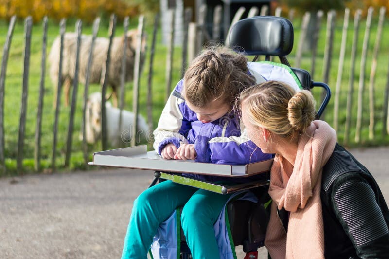 Disabled girl in a wheelchair relaxing outside