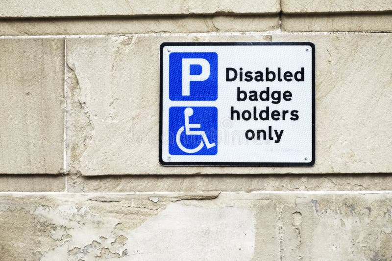 Disabled Badge Holders Only at Car Park Sign on Wall