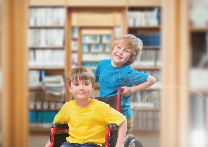 Disabled boy in wheelchair with friend in school library royalty free stock image Disabled boy in wheelchair with friend in school library royalty free stock image
