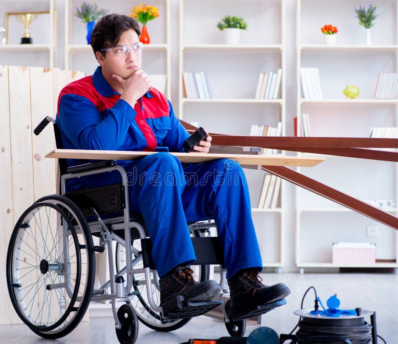 Disabled Carpenter Working With Tools In Workshop Stock 