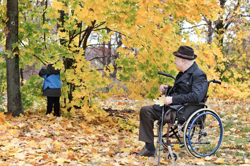 Disabled grandfather and grandchild outdoors.