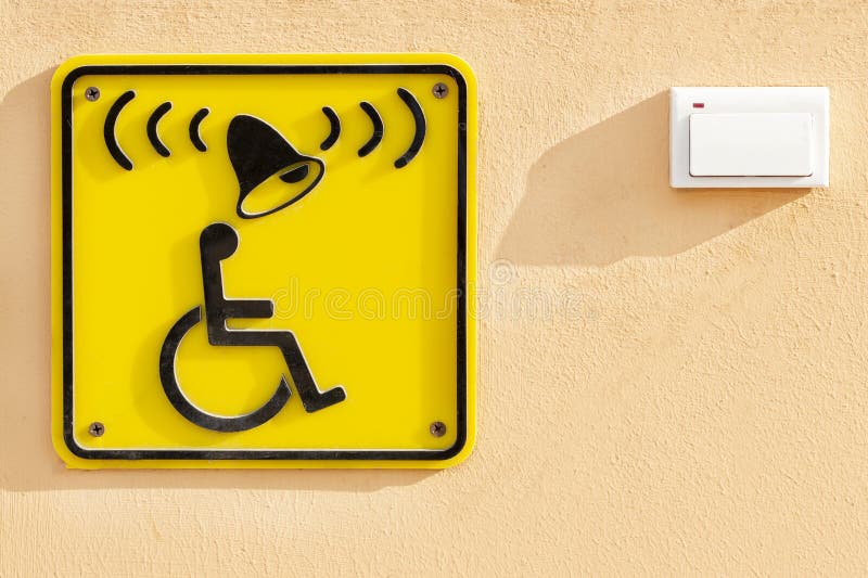 Disabled help call button. yellow plate with the image of a disabled person and a call button stock images Disabled help call button. yellow plate with the image of a disabled person and a call button stock images