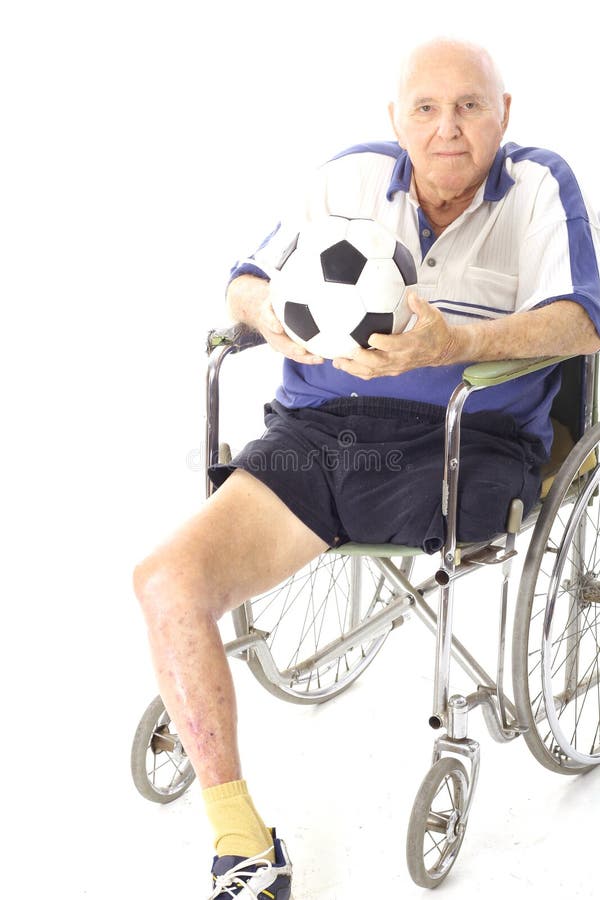 Disabled man in wheelchair with soccer ball