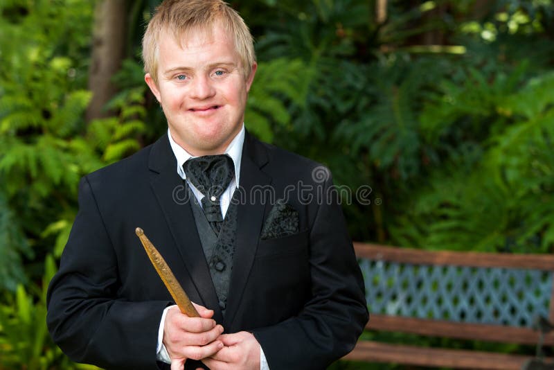 Portrait of handicapped drummer boy in black suit outdoors. Portrait of handicapped drummer boy in black suit outdoors.