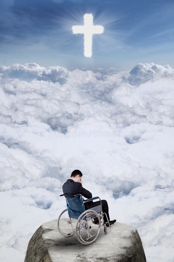 Disabled person sitting on wheelchair at the cliff