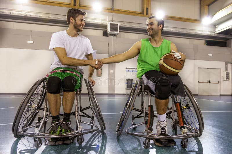 Disabled sport men in action while playing indoor basketball