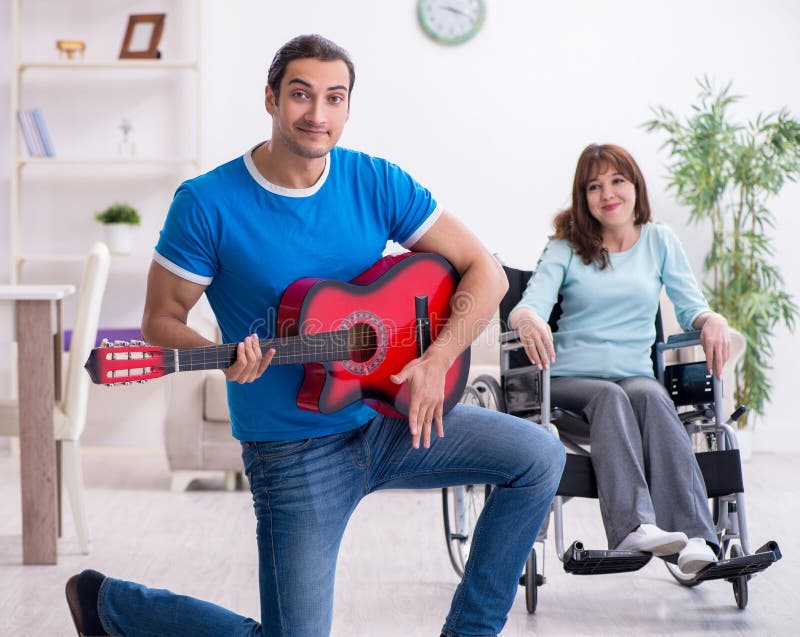 Disabled wife and young husband at home stock photography
