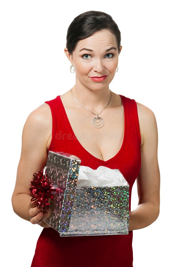 A woman disappointed woman holding a christmas gift she just opened. Isolated on white. A woman disappointed woman holding a christmas gift she just opened. Isolated on white.