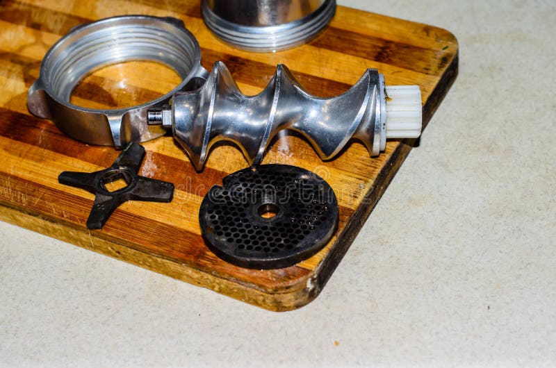 Disassembled Electric Meat Grinder on the Cutting Board Stock Photo