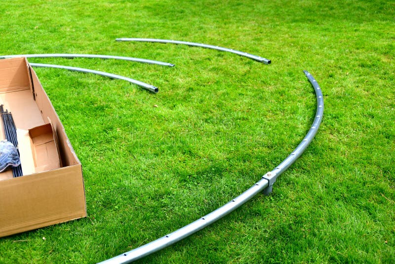 Disassembled Trampoline in the Yard after Purchase. Assembly and