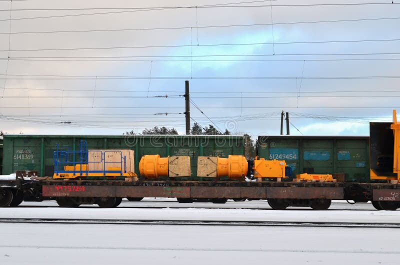 Disassembled mining truck loaded onto a railway platform costs railway tracks in the industrial area of the customs royalty free stock photography