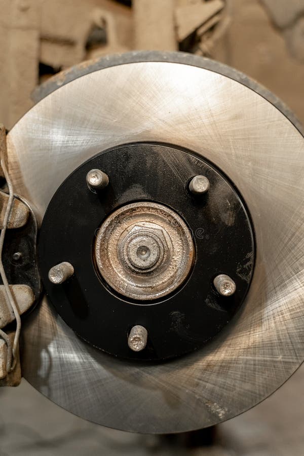 Disc Brake on a Car, Brake Disc Replacement in a Car Service. the Rim