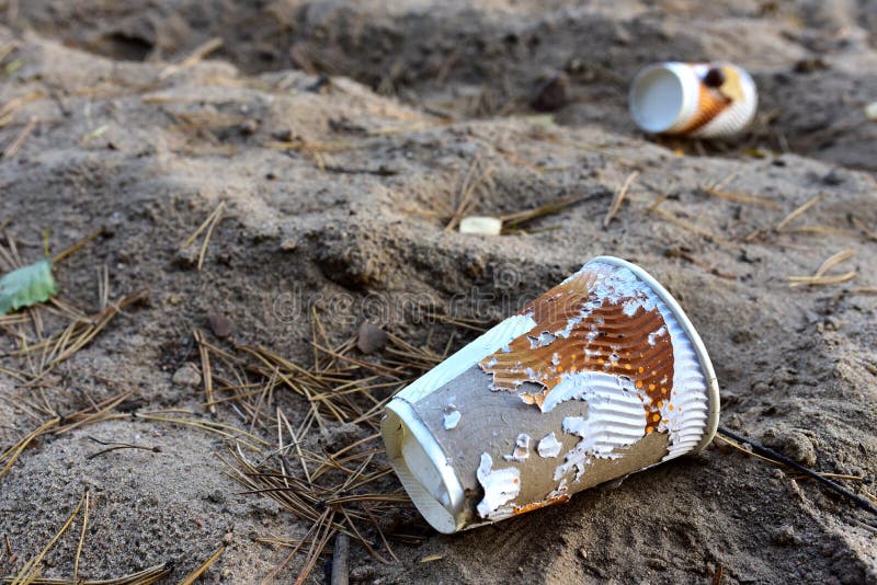 Discarded Paper Coffee Cup on Ground. Disposable Coffee Cup on Sand