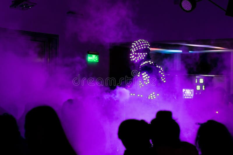 Disco um robô em um terno claro com fumo fotografia de stock Disco um robô em um terno claro com fumo fotografia de stock