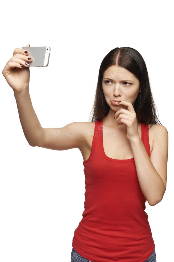 Discontent woman taking pictures of herself through cellphone