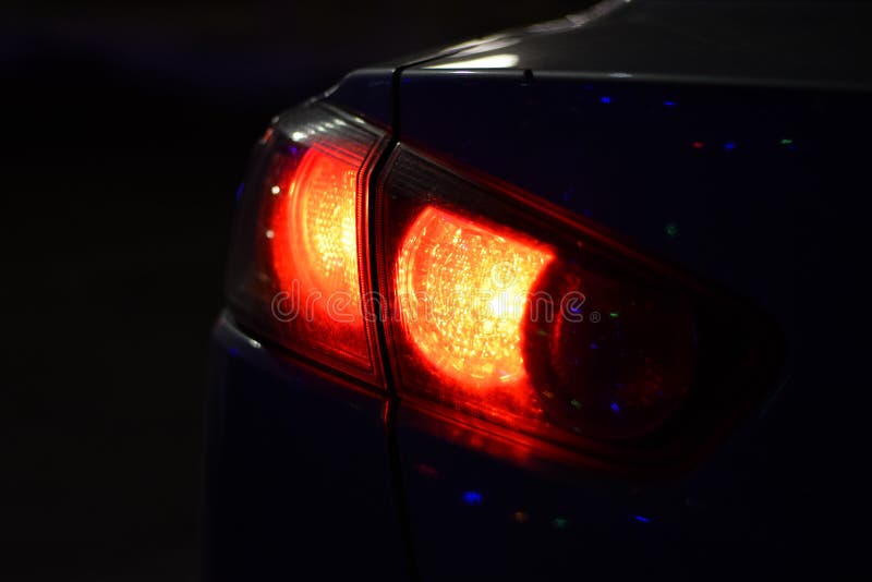 Discounted Rear Car Lights in the Dark. Stop Signals Stock Photo