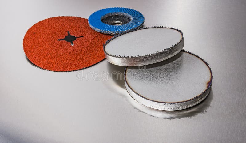 Discs abrasive flap wheels on metallic background.