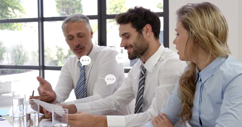 Discussing documents, three colleagues in office with animation of chat bubble icons stock video