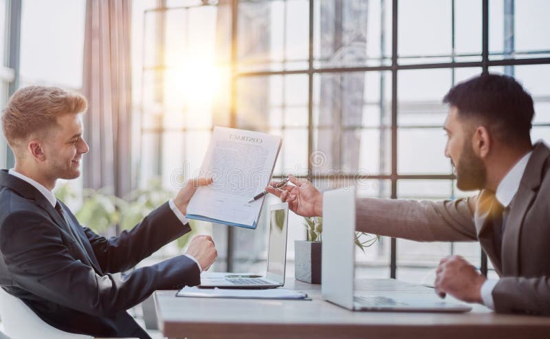 Two happy men working together on a new business project royalty free stock images