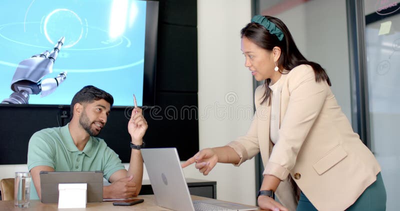 Discussing robotic technology, colleagues collaborating with laptop in modern office stock footage