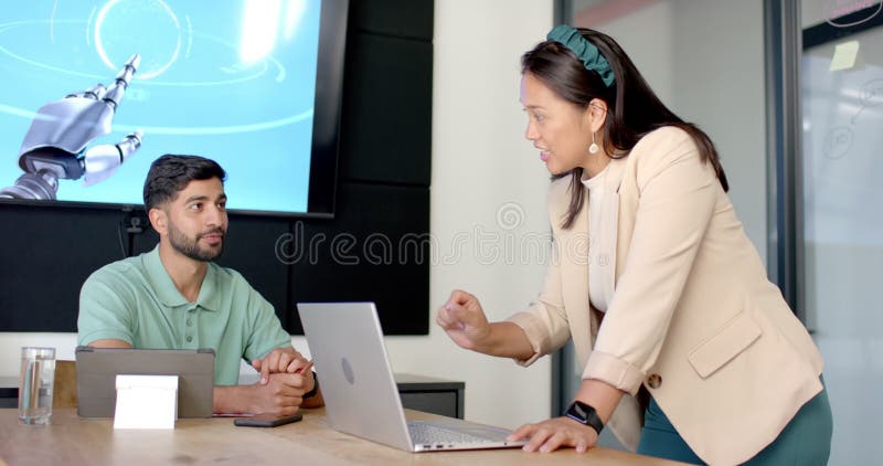 Discussing robotics project, colleagues collaborating with laptop in modern office stock video footage