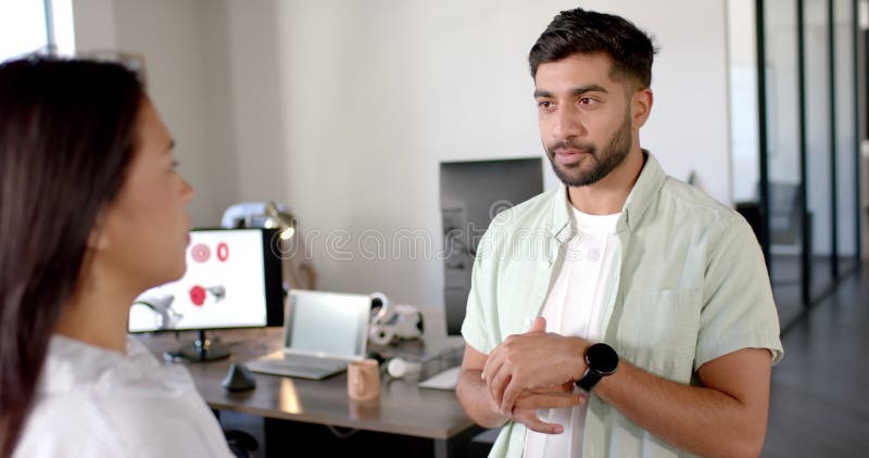 Discussing robotics project, colleagues in modern office with computer and gadgets stock video footage