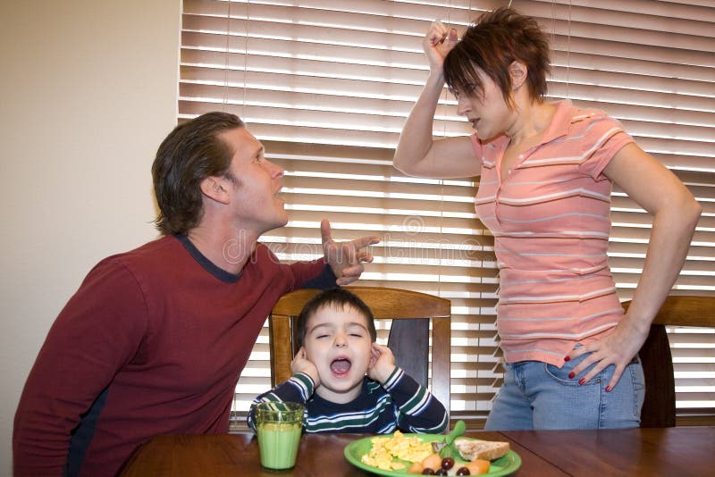 Thirty something couple at home fighting with upset son between them. Thirty something couple at home fighting with upset son between them.