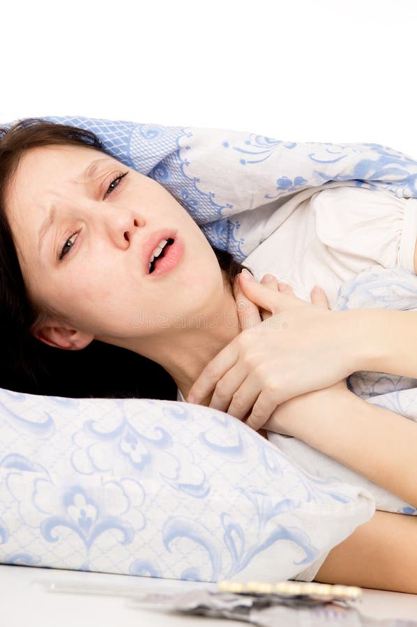 The diseased girl lying on the bed, a sore throat