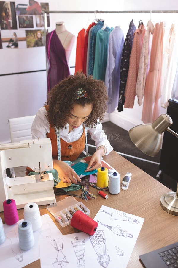 Diseñador de moda de sexo femenino que trabaja en estudio del diseño fotos de archivo libres de regalías Diseñador de moda de sexo femenino que trabaja en estudio del diseño fotos de archivo libres de regalías