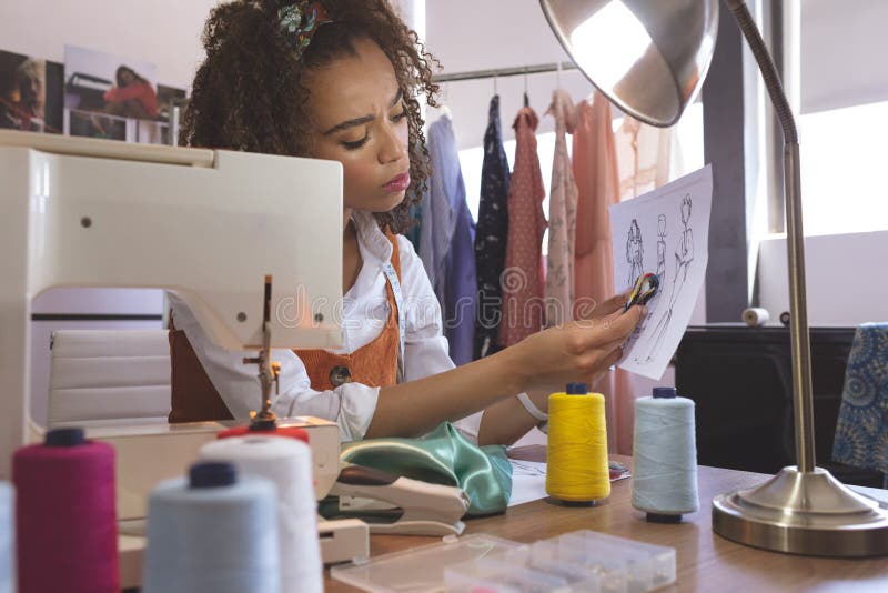 Diseñador de moda de sexo femenino que trabaja en estudio del diseño foto de archivo libre de regalías Diseñador de moda de sexo femenino que trabaja en estudio del diseño foto de archivo libre de regalías