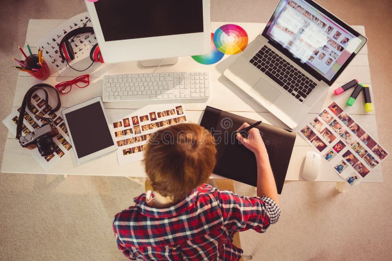 Graphic designer working at desk in office. Graphic designer working at desk in office