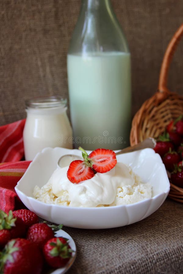 Dish of Cottage Cheese with Cream and a Bottle of Milk Stock Photo