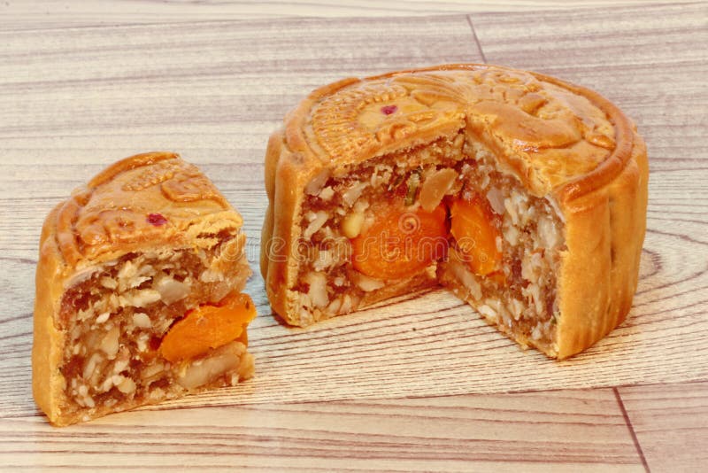 A dish of Mooncake filling five seed and salt eggs on wood. Close up focus. stock photo A dish of Mooncake filling five seed and salt eggs on wood. Close up focus. stock photo